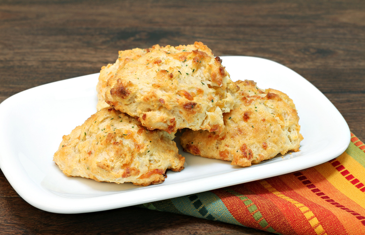 Three stacked cheddar, parsley and garlic biscuits.