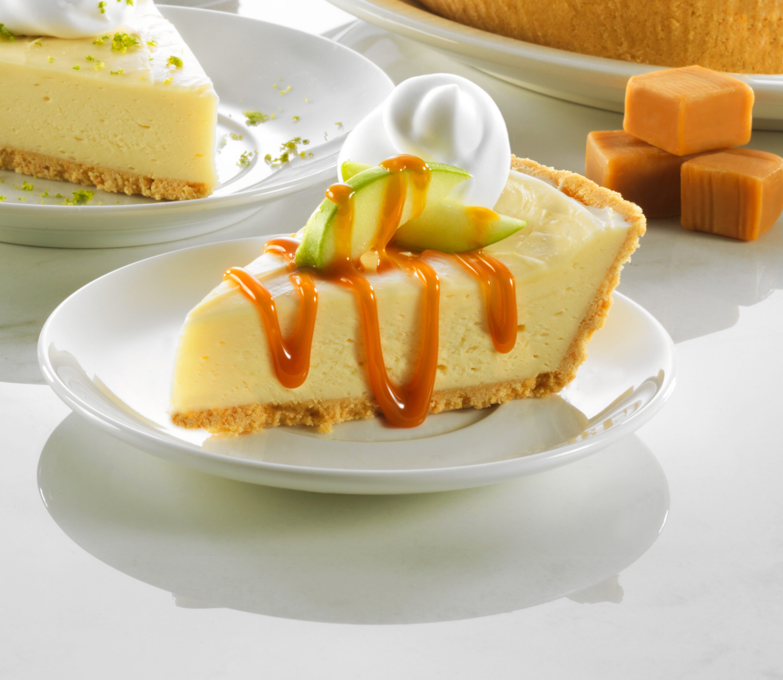 A slice of pie on a plate, drizzled with rich caramel sauce, inviting and deliciously presented.