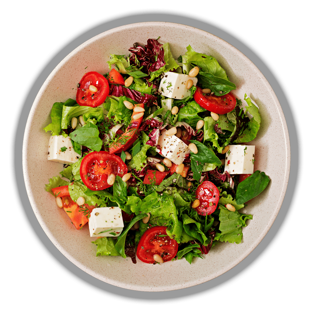 Dietary salad with tomatoes, feta, lettuce, spinach and pine nuts. Top view. Flat lay.